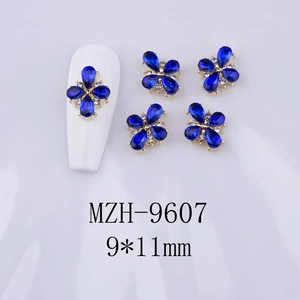 Detail of blue teardrop clover nail charms sized 9x11mm on white background