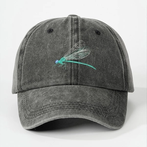 Close-up of the detailed dragonfly embroidery on washed dark grey cotton baseball cap