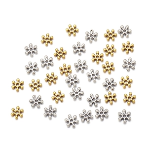 Detailed top view of 7mm gold and silver snowflake metal spacers for DIY jewelry making