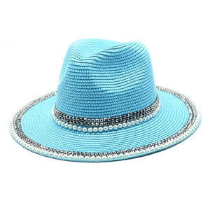 Detail of sky blue straw fedora featuring white faux pearls and silver cone stud trim