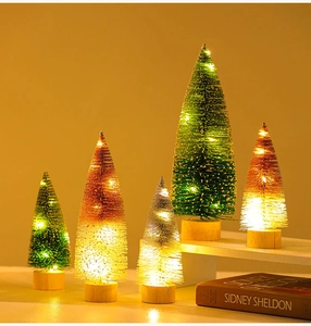 Detail of five mini glowing Christmas trees with glitter finish on wooden bases