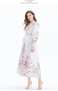 Detailed close-up of vibrant floral print and lantern sleeves on a V-neck linen maxi dress
