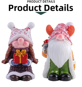 Close-up of resin Christmas gnomes with reindeer hat and gift box table ornaments