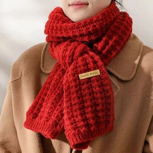 Red knit winter scarf in thick waffle weave pattern with a brown handmade leather tag