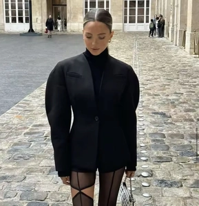 Detail of elegant V-neck puff sleeve blazer coat in a street style setting
