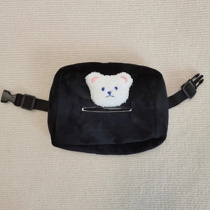 Close-up of black plush car tissue holder with cute bear motif and adjustable strap