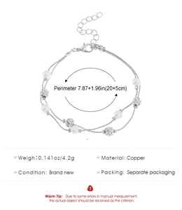 Detailed view of a double-layer pearl bracelet with starfish charms and lobster clasp