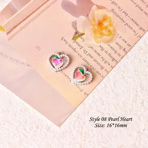 Macro shot of 16x16mm heart pearl charms with tulip motif for DIY jewelry making