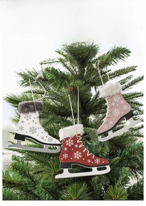 Detail of wooden ice skate ornaments with snowflake patterns on Christmas tree branches