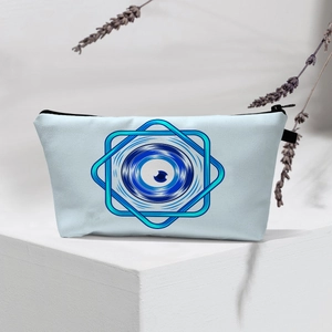 Detailed view of light blue Evil Eye waterproof makeup bag on a white podium with lavender