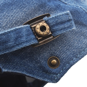 Blue denim beret back view featuring a vintage bronze star buckle and metal snap button