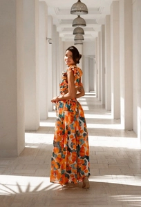 Detailed view of backless summer dress with orange floral print and airy chiffon fabric