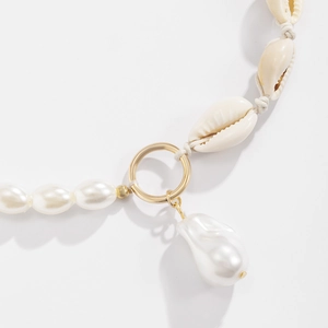 Elegant baroque pearl necklace with natural conch shells and a gold-tone pendant