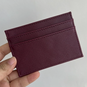 Detail view of burgundy Saffiano PU leather card holder with multiple functional slots