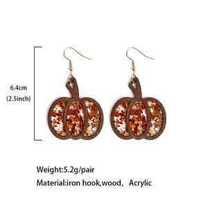 Halloween pumpkin earrings made of wood and orange glitter acrylic on white background