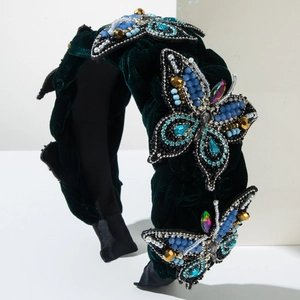 Detail of dark green velvet headband with hand-sewn crystal butterfly and pearl embroidery