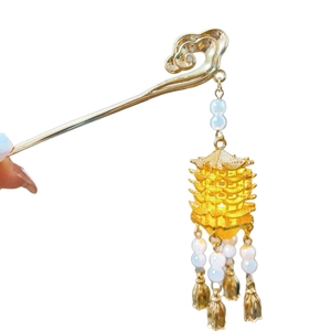 Golden Chinese hair pin with yellow crane tower pendant and flowing metal tassels