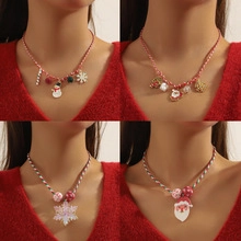 Detailed view of four festive Christmas necklaces featuring Santa and snowman pendants