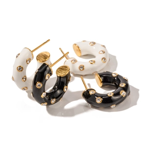 Elegant C-shaped earrings with black and white enamel finish and sparkling crystals