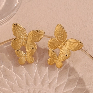 Detailed close-up of 18K gold plated stainless steel butterfly earrings with fine texture