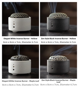 Close-up of ceramic incense burners in black and white with vintage metal lids