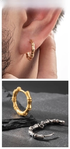 Macro detail of bamboo-style stainless steel hoop earrings in gold and silver finish