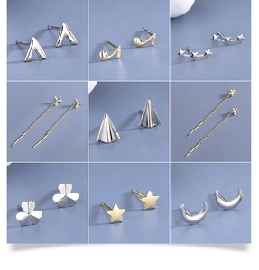 Macro display of S925 silver moon and star stud earrings with various geometric designs