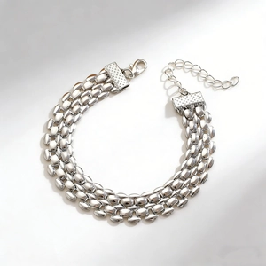 Detailed macro view of silver watch-band chain bracelet with lobster clasp and extension