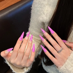 Pink and nude long stiletto press-on nails with glitter and crown ring decoration