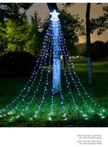 Cold white LED star waterfall string lights hanging on a tree for outdoor Christmas decor