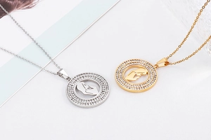 Detailed macro view of gold and silver plated hollow prayer girl pendant necklaces