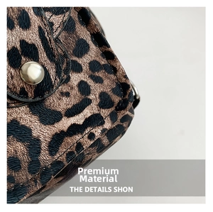 Macro shot of leopard print fabric texture and silver round metal snap button detail
