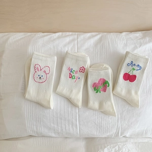 Set of four white cotton crew socks for girls featuring cute heart and cartoon embroidery