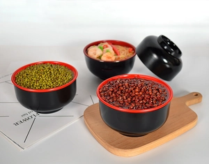 Detailed close-up of realistic faux red bean soup model in classic black and red bowls