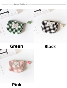 Detailed view of houndstooth coin purses in green, black and pink with tassels
