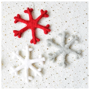 Detailed view of handmade wool felt snowflake ornaments in red, white and grey colors
