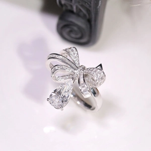 Bowknot silver ring with a pear-cut waterdrop diamond pendant in a luxury aesthetic