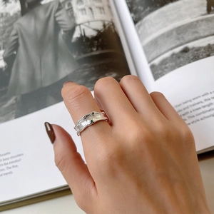S925 sterling silver irregular lava ring with dual green gemstones on fashion magazine