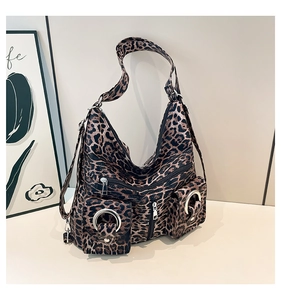 Detailed view of leopard print tote bag featuring two front pockets with metal rings