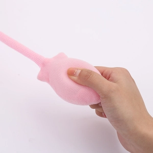 Detail showing the soft texture and pink knitted fabric of the rabbit ear hat