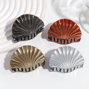 Minimalist seashell-shaped hair claws in assorted metallic colors for stylish hair styling