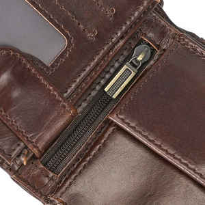 Detail view of genuine leather wallet showing stitching, zipper, and clear ID window