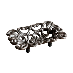 Vintage cast iron soap dish with openwork floral pattern and rustic bronze finish