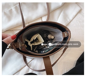 Top view detail of retro bucket bag interior showing large capacity for daily essentials