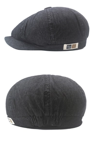 Detail of grey striped newsboy cap featuring side textile label and elastic back design