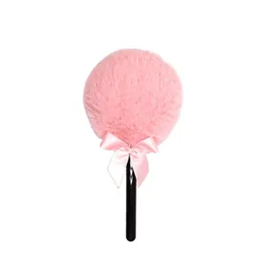 Pink plush lollipop powder puff with soft long fur and satin bow for makeup and beauty