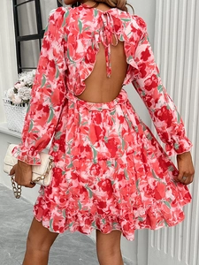 Detailed back view of mini dress featuring open back design and delicate floral patterns