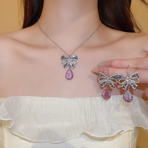 Detail of necklace and earrings set with butterfly zircon and pink water drop stones