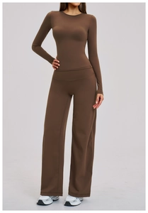 Detail of high-stretch dark brown yoga set with wide-leg pants and slim-fit long sleeve top