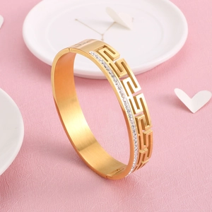 Gold stainless steel wide cuff bracelet with Greek Key cutouts and sparkling crystals